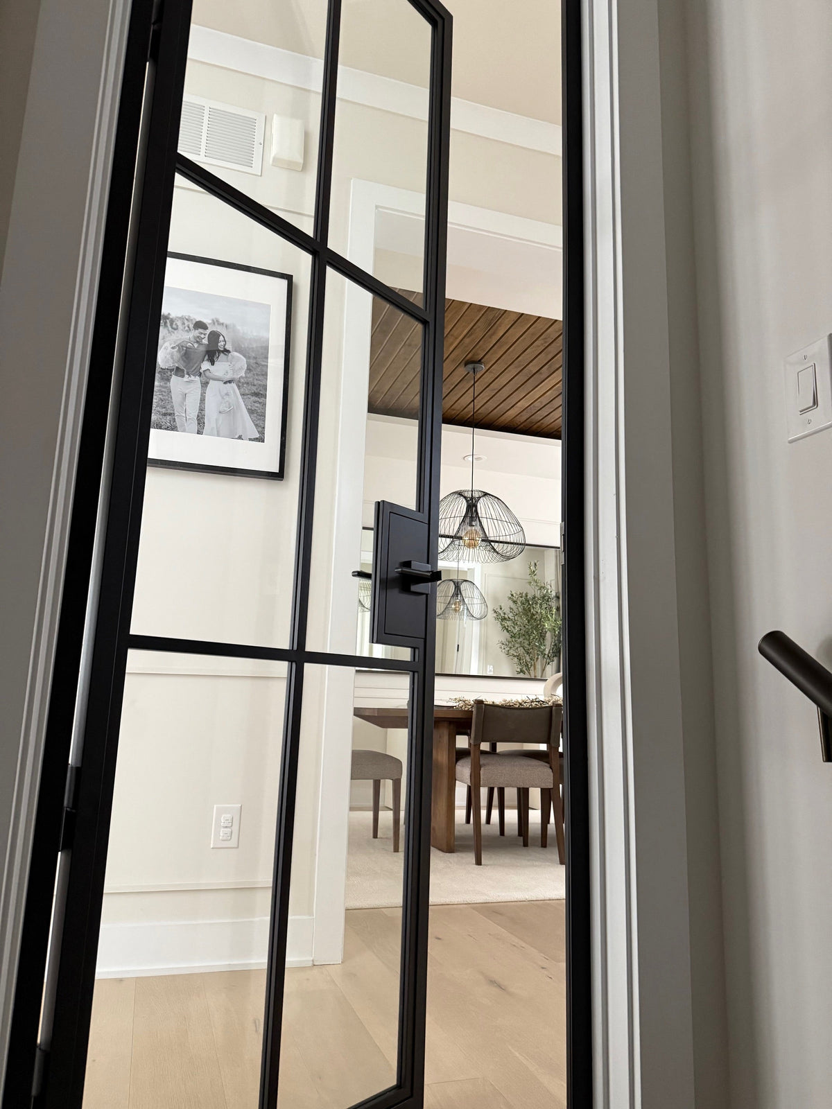 Matte black 6 Lite steel French door with clear glass at the top of a basement stairwell, Pennsylvania
