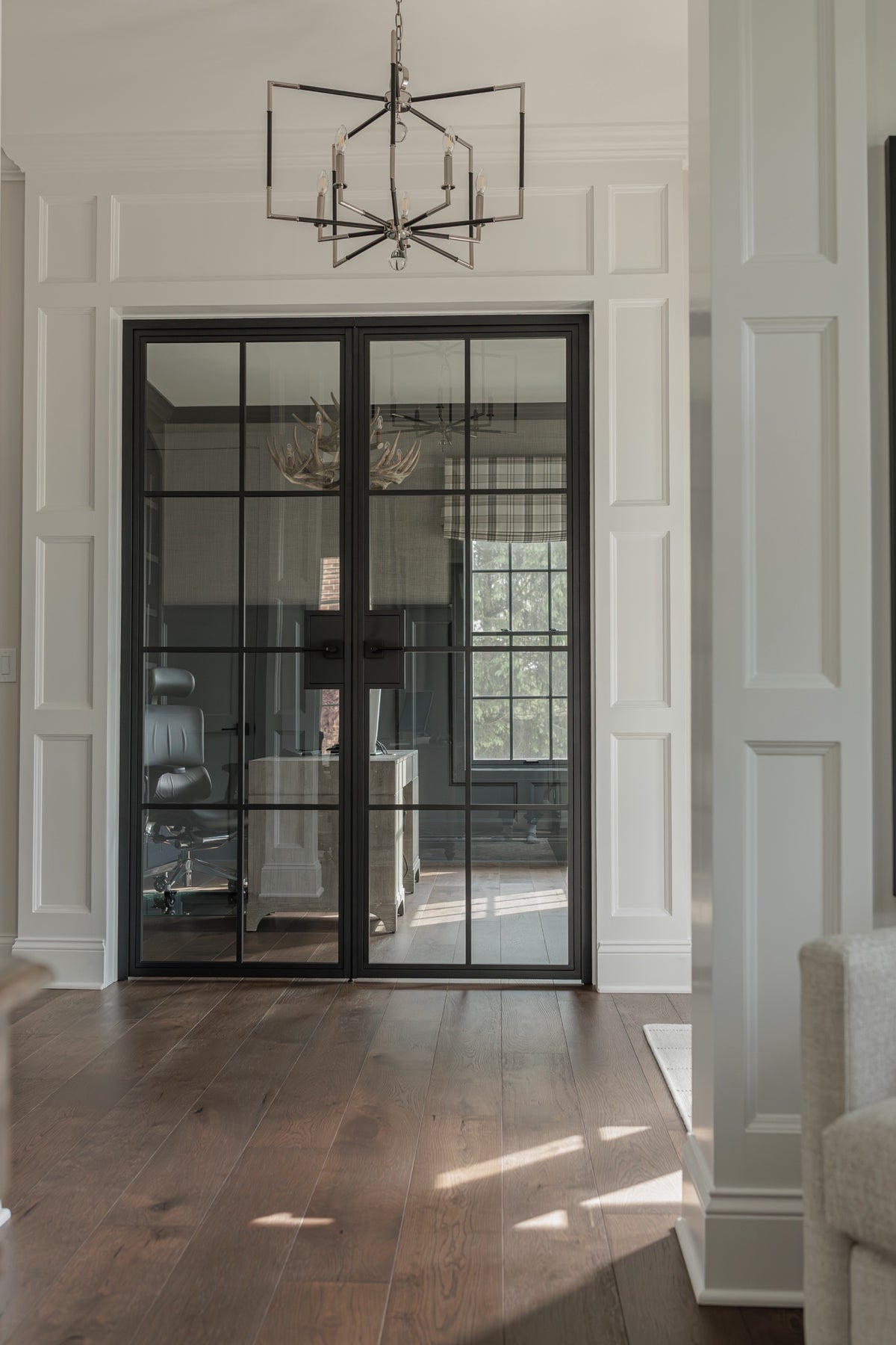 Closed 8 Lite steel French double door with clear glass and matte black frame, seen from the hallway