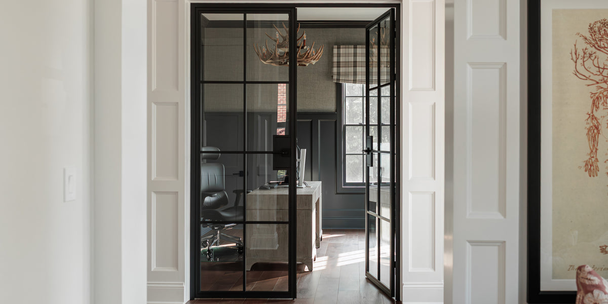 Black steel French double door with clear glass, one leaf open to a home office