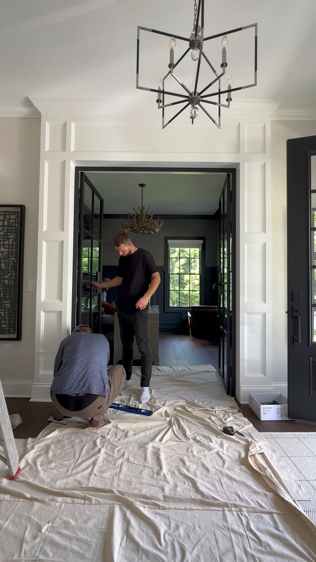 Installing black steel double doors in a foyer