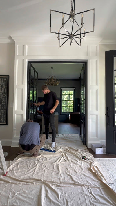 Installing black steel double doors in a foyer